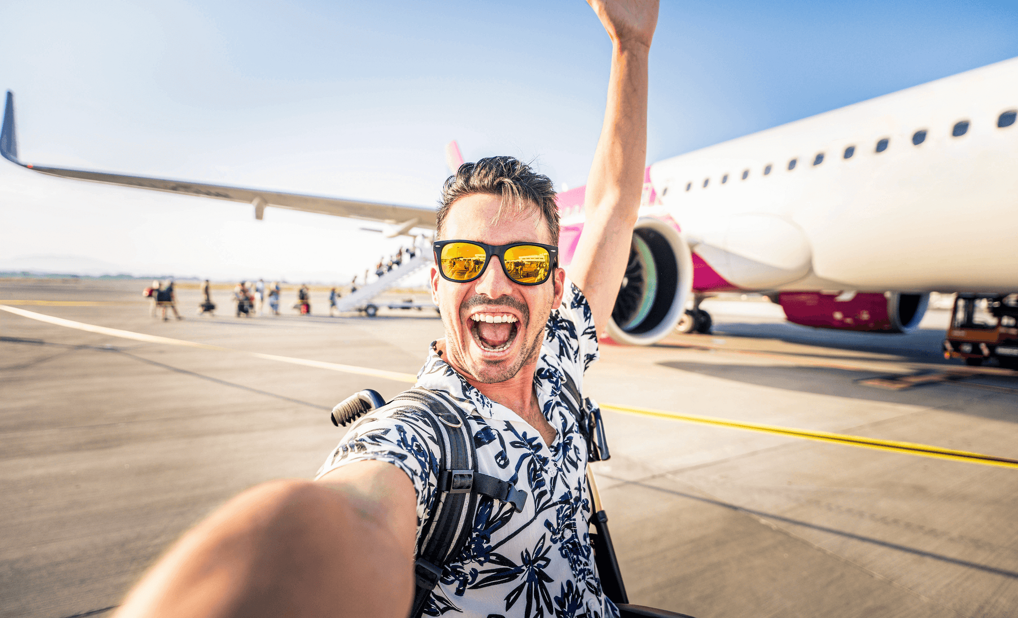 Excited traveller taking a selfie while boarding a plane, symbolising the confident, carefree experience Supr Bueno offers by answering all your website and design-related questions on our FAQ page.